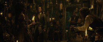 Movie still from “Pirates of the Caribbean: Dead Man's Chest” (2006), directed by Gore Verbinski – A man standing in front of a group of people; Medium shot, Over the shoulder angle