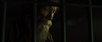 Movie still from “Pirates of the Caribbean: Dead Men Tell No Tales” (2017), directed by Espen Sandberg – An old man with a long white beard behind bars; Close Up shot, Low angle
