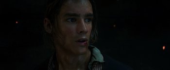 Movie still from “Pirates of the Caribbean: Dead Men Tell No Tales” (2017), directed by Espen Sandberg – A young man with wet hair and a bruised face; Close Up shot, Low angle