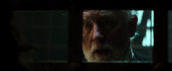 Movie still from “Pirates of the Caribbean: Dead Men Tell No Tales” (2017), directed by Espen Sandberg – An older man looking out a window at night; Close Up shot, Over the shoulder angle