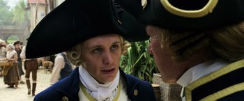 Movie still from “Pirates of the Caribbean: Dead Men Tell No Tales” (2017), directed by Espen Sandberg – A man wearing a pirate's hat talking to another man; Close Up shot, Over the shoulder angle