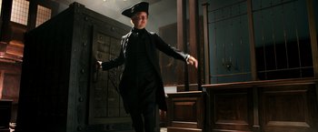 Movie still from “Pirates of the Caribbean: Dead Men Tell No Tales” (2017), directed by Espen Sandberg – A man dressed in a black suit and a hat; Medium shot, Low angle
