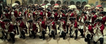 Movie still from “Pirates of the Caribbean: Dead Men Tell No Tales” (2017), directed by Espen Sandberg – A group of men in red and white uniforms and hats; Wide shot, High angle