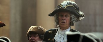 Movie still from “Pirates of the Caribbean: Dead Men Tell No Tales” (2017), directed by Espen Sandberg – A man in a pirate costume and a man in a pirate hat; Close Up shot, Over the shoulder angle