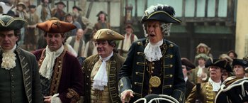 Movie still from “Pirates of the Caribbean: Dead Men Tell No Tales” (2017), directed by Espen Sandberg – Two men dressed in period costumes and hats; Medium shot, Over the shoulder angle