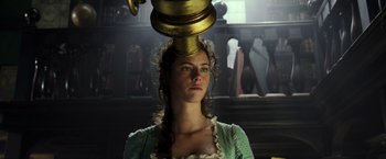 Movie still from “Pirates of the Caribbean: Dead Men Tell No Tales” (2017), directed by Espen Sandberg – A woman with a gold pot on top of her head; Close Up shot, Low angle