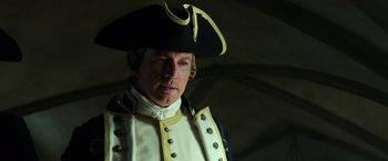 Movie still from “Pirates of the Caribbean: Dead Men Tell No Tales” (2017), directed by Espen Sandberg – A man wearing a hat and a uniform; Close Up shot, Low angle