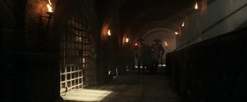 Movie still from “Pirates of the Caribbean: Dead Men Tell No Tales” (2017), directed by Espen Sandberg – A group of people walking through a tunnel; Wide shot, Low angle