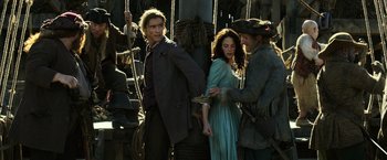 Movie still from “Pirates of the Caribbean: Dead Men Tell No Tales” (2017), directed by Espen Sandberg – A man and a woman standing next to each other on a boat; Medium shot, Over the shoulder angle