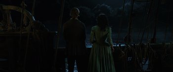 Movie still from “Pirates of the Caribbean: Dead Men Tell No Tales” (2017), directed by Espen Sandberg – A man and a woman standing next to each other; Wide shot, High angle