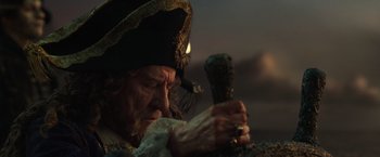 Movie still from “Pirates of the Caribbean: Dead Men Tell No Tales” (2017), directed by Espen Sandberg – A man wearing a pirate hat and holding a sword; Close Up shot, Over the shoulder angle