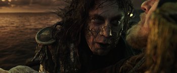 Movie still from “Pirates of the Caribbean: Dead Men Tell No Tales” (2017), directed by Espen Sandberg – A person's face in a dark setting; Close Up shot, Low angle