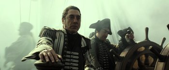 Movie still from “Pirates of the Caribbean: Dead Men Tell No Tales” (2017), directed by Espen Sandberg – Two men dressed in military garb are posing for a picture; Medium shot, Over the shoulder angle