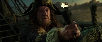 Movie still from “Pirates of the Caribbean: Dead Men Tell No Tales” (2017), directed by Espen Sandberg – A man dressed as a pirate holding a sword; Close Up shot, Low angle