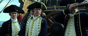 Movie still from “Pirates of the Caribbean: Dead Men Tell No Tales” (2017), directed by Espen Sandberg – A man in a uniform and a hat; Close Up shot, Over the shoulder angle