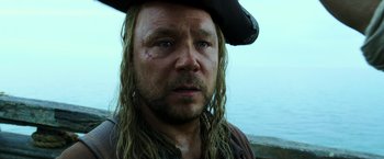 Movie still from “Pirates of the Caribbean: Dead Men Tell No Tales” (2017), directed by Espen Sandberg – A person wearing a pirate hat; Close Up shot, Over the shoulder angle