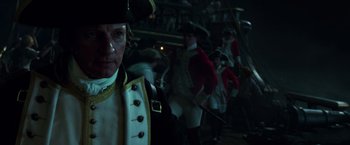 Movie still from “Pirates of the Caribbean: Dead Men Tell No Tales” (2017), directed by Espen Sandberg – A group of people in uniforms and hats; Medium shot, Over the shoulder angle