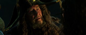 Movie still from “Pirates of the Caribbean: Dead Men Tell No Tales” (2017), directed by Espen Sandberg – A person wearing a pirate hat; Close Up shot, Over the shoulder angle