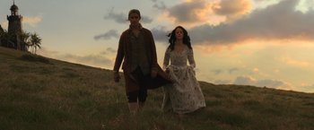 Movie still from “Pirates of the Caribbean: Dead Men Tell No Tales” (2017), directed by Espen Sandberg – A man and a woman walking through a field; Wide shot, Low angle