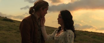 Movie still from “Pirates of the Caribbean: Dead Men Tell No Tales” (2017), directed by Espen Sandberg – A man and a woman standing next to each other in a field; Close Up shot, Over the shoulder angle