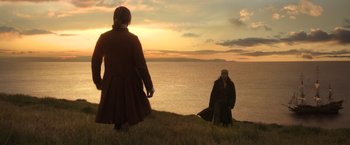 Movie still from “Pirates of the Caribbean: Dead Men Tell No Tales” (2017), directed by Espen Sandberg – Two people standing on top of a hill near the ocean; Wide shot, Over the shoulder angle