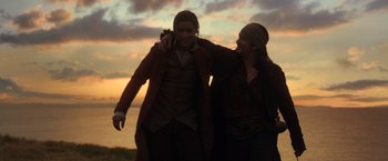 Movie still from “Pirates of the Caribbean: Dead Men Tell No Tales” (2017), directed by Espen Sandberg – A man and a woman standing next to each other on a beach; Medium shot, Low angle