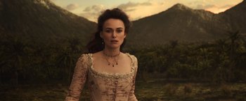 Movie still from “Pirates of the Caribbean: Dead Men Tell No Tales” (2017), directed by Espen Sandberg – A woman wearing a long dress standing in front of a mountain range; Close Up shot, Over the shoulder angle