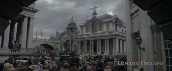 Movie still from “Pirates of the Caribbean: On Stranger Tides” (2011), directed by Rob Marshall – A crowd of people gathered in front of a building; Extreme Wide shot, High angle