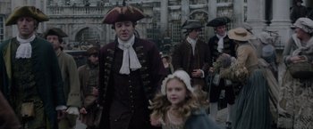 Movie still from “Pirates of the Caribbean: On Stranger Tides” (2011), directed by Rob Marshall – A man and a little girl are walking together; Medium shot, High angle