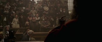 Movie still from “Pirates of the Caribbean: On Stranger Tides” (2011), directed by Rob Marshall – A group of people sitting in front of an audience; Wide shot, High angle