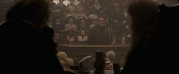 Movie still from “Pirates of the Caribbean: On Stranger Tides” (2011), directed by Rob Marshall – A crowd of people sitting and standing in a room; Wide shot, High angle
