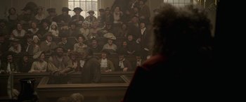 Movie still from “Pirates of the Caribbean: On Stranger Tides” (2011), directed by Rob Marshall – A group of people sitting in front of an audience; Wide shot, High angle