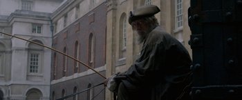 Movie still from “Pirates of the Caribbean: On Stranger Tides” (2011), directed by Rob Marshall – An old man with a long beard holding a bow and arrow; Medium shot, Over the shoulder angle