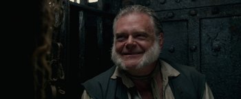 Movie still from “Pirates of the Caribbean: On Stranger Tides” (2011), directed by Rob Marshall – An older man with a beard smiling for the camera; Close Up shot, Over the shoulder angle