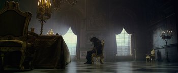 Movie still from “Pirates of the Caribbean: On Stranger Tides” (2011), directed by Rob Marshall – A person sitting on a chair in a room; Wide shot, Low angle