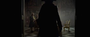 Movie still from “Pirates of the Caribbean: On Stranger Tides” (2011), directed by Rob Marshall – A group of people standing around in a room; Wide shot, Over the shoulder angle