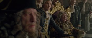Movie still from “Pirates of the Caribbean: On Stranger Tides” (2011), directed by Rob Marshall – A group of people sitting in a room; Medium shot, Low angle