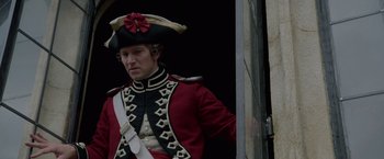 Movie still from “Pirates of the Caribbean: On Stranger Tides” (2011), directed by Rob Marshall – A man dressed in a red and black uniform and a hat; Medium shot, Over the shoulder angle