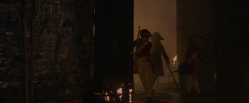 Movie still from “Pirates of the Caribbean: On Stranger Tides” (2011), directed by Rob Marshall – Two people in period clothing walking in front of a fire; Wide shot, Low angle