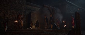 Movie still from “Pirates of the Caribbean: On Stranger Tides” (2011), directed by Rob Marshall – A group of people standing in front of a building; Extreme Wide shot, Low angle
