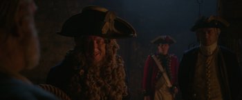 Movie still from “Pirates of the Caribbean: On Stranger Tides” (2011), directed by Rob Marshall – A man in a pirate costume and a man in a uniform; Medium shot, Over the shoulder angle