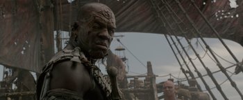 Movie still from “Pirates of the Caribbean: On Stranger Tides” (2011), directed by Rob Marshall – A man with a strange face is standing next to another man; Close Up shot, Low angle