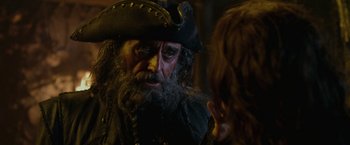 Movie still from “Pirates of the Caribbean: On Stranger Tides” (2011), directed by Rob Marshall – A man with a beard and a pirate's hat on; Close Up shot, Over the shoulder angle