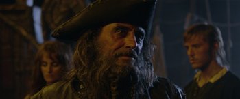 Movie still from “Pirates of the Caribbean: On Stranger Tides” (2011), directed by Rob Marshall – A person wearing a pirate hat; Close Up shot, Over the shoulder angle