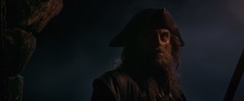 Movie still from “Pirates of the Caribbean: On Stranger Tides” (2011), directed by Rob Marshall – A person wearing a pirate costume; Close Up shot, Low angle