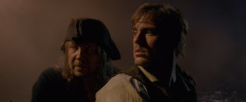 Movie still from “Pirates of the Caribbean: On Stranger Tides” (2011), directed by Rob Marshall – Two men standing next to each other wearing hats; Close Up shot, Over the shoulder angle