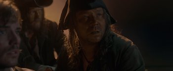Movie still from “Pirates of the Caribbean: On Stranger Tides” (2011), directed by Rob Marshall – A person wearing a pirate hat; Close Up shot, Over the shoulder angle