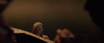 Movie still from “Pirates of the Caribbean: On Stranger Tides” (2011), directed by Rob Marshall – A woman is looking at the camera in the dark; Close Up shot, Over the shoulder angle