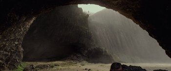 Movie still from “Pirates of the Caribbean: On Stranger Tides” (2011), directed by Rob Marshall – A person standing inside of a cave on a cliff; Extreme Wide shot, Low angle