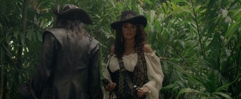 Movie still from “Pirates of the Caribbean: On Stranger Tides” (2011), directed by Rob Marshall – A woman dressed as a pirate holding a gun; Medium shot, Over the shoulder angle